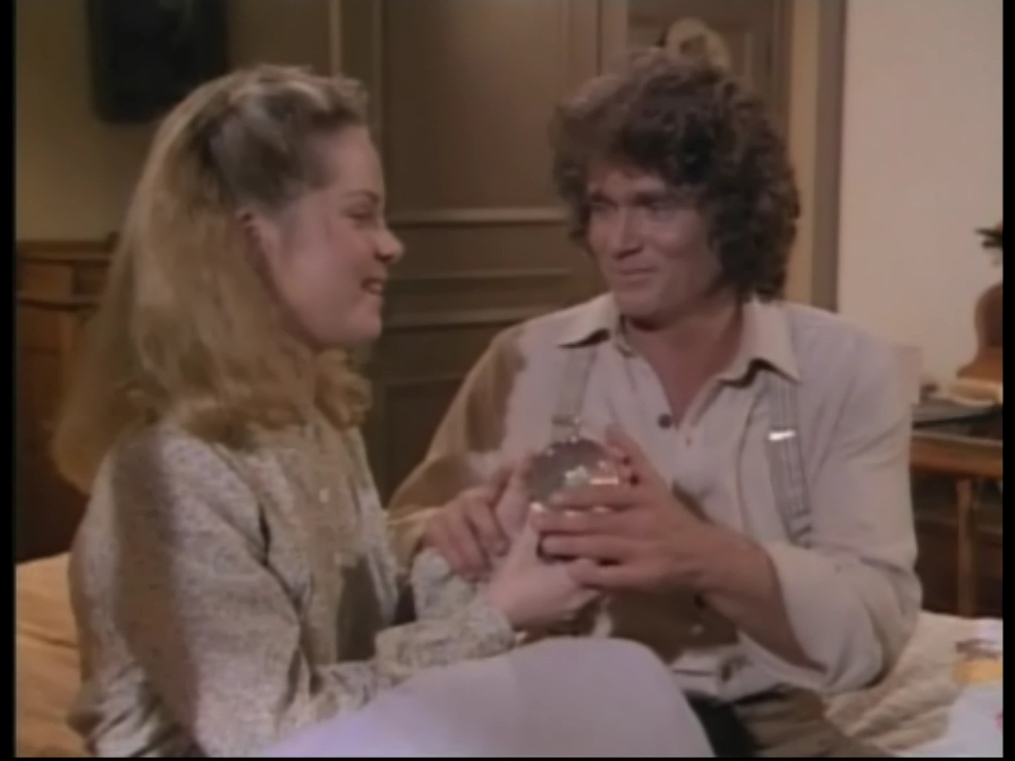 Melissa Sue Anderson as Mary Ingalls with Michael Landon as Charles Ingalls holding a snow globe